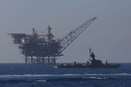 An Israeli Navy vessel (R) patrols near an Israeli gas platform, run by a U.S.-Israeli energy group that also controls the undeveloped Leviathan field, in the Mediterranean sea in this file picture taken August 1, 2014. REUTERS/Amir Cohen