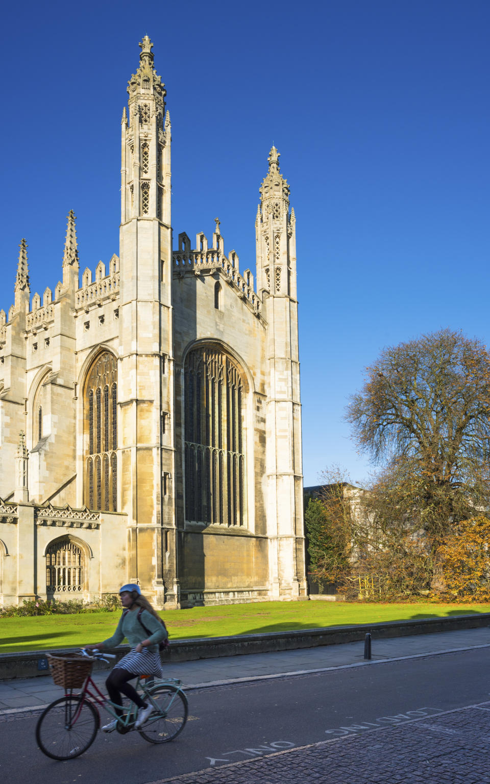 Cyclists go past Kings College Chapel on Kings Parade, Cambridge University, Cambridgeshire, England, UK. (Photo by: Education Images/Universal Images Group via Getty Images)