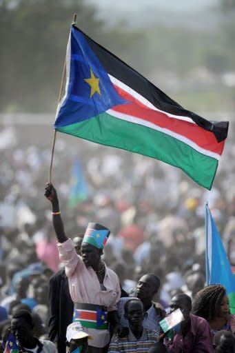 A Southern Sudanes man waves a Southern Sudan flag as he joined thousands of others during a ceremony in the capital Juba. Celebrations erupted in South Sudan on Saturday as the world's newest nation proclaimed formal independence and turned the page on five decades of devastating conflict with the north