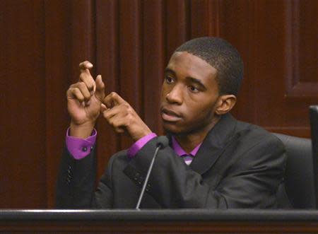 Witness Leland Brunson shows how Michael Dunn pulled back the slide on his weapon as he testifies in Dunn's first-degree murder trial in Jacksonville, Florida February 7, 2014. REUTERS/Bob Mack/The Florida Times-Union/Pool