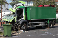 The scene of a collision in Broad Walk, Kidbrooke, south-east London, where the driver of a lorry which hit two cars before crashing into a house has died and an 11-year-old child is in a life-threatening condition in hospital.