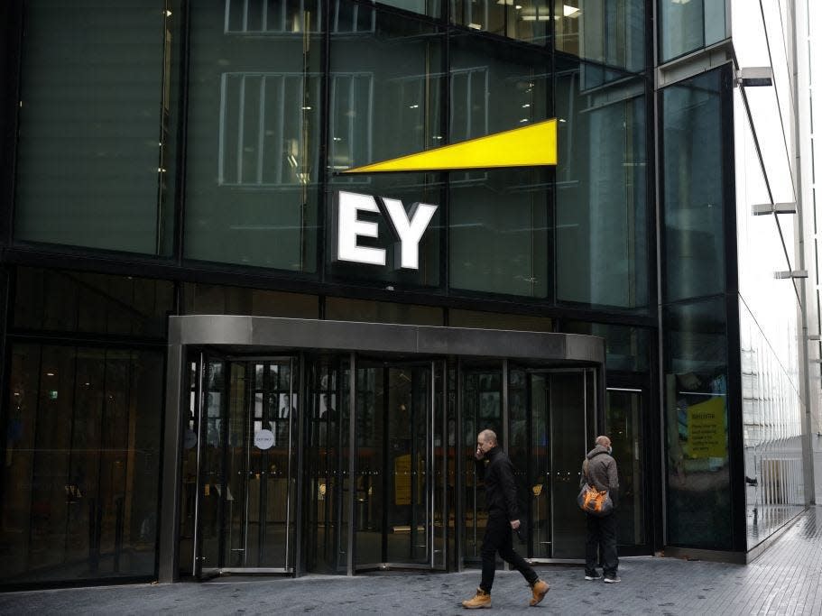 Pedestrians walk past the offices of accounting and auditing firm EY, formerly Ernst & Young, in London on November 20, 2020.