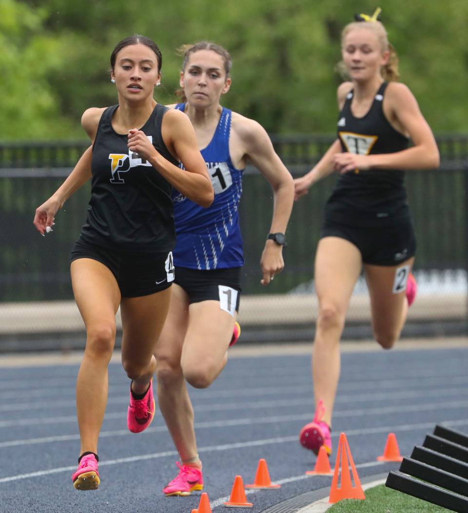 Padua's Sophia Holgado (front) leads heading into the final stretch as she wins the 800 meter race ahead of second place finisher Isabelle Walsh of Middletown (center) and Tatnall's Katie Payne (third place) during the New Castle County Track and Field Championships at Abessinio Stadium, Saturday, May 13, 2023.