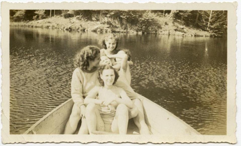 Teenagers in a rowboat at summer camp, from the Records of the Hebrew Orphan Asylum of the City of New York.