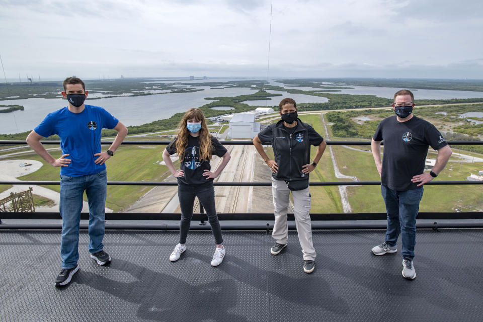 In this photo provided by SpaceX, Jared Isaacman, from left to right, Hayley Arceneaux, Sian Proctor and Chris Sembroski pose for a photo, Monday, March 29, 2021, from the SpaceX launch tower at NASA’s Kennedy Space Center at Cape Canaveral, Fla. (SpaceX via AP)