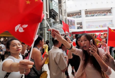 Pro-government and anti-government supporters chant against one another at a shopping mall in Hong Kong