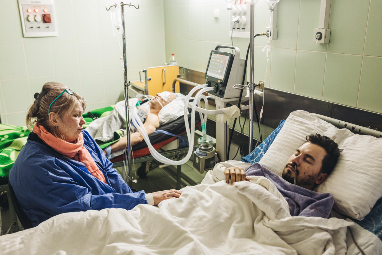 KHARKIV, UKRAINE - MARCH 13: Ileana looks at her 29-year-old son Sergei, a volunteer who was hit by a bullet and is in a hospital in Kharkov, Ukraine, on March 13, 2022 as Russian attacks continue. (Photo by Diego Herrera Carcedo/Anadolu Agency via Getty Images)