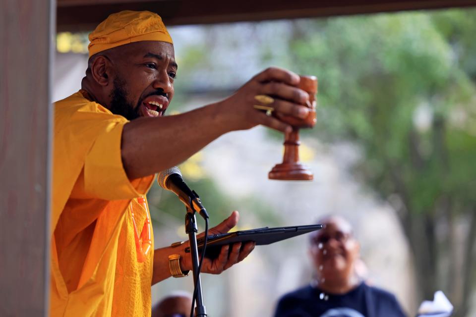 Jacksonville City Council member Rahman Johnson delivers a libation pouring – a spiritual act, with African origins, thanking ancestors and asking for blessings – during a "Banned Book Readout" Thursday at James Weldon Johnson Park, an event organized through the Association for the Study of African American Life and History (ASALH), a 108-year-old Black studies group holding its national conference downtown.