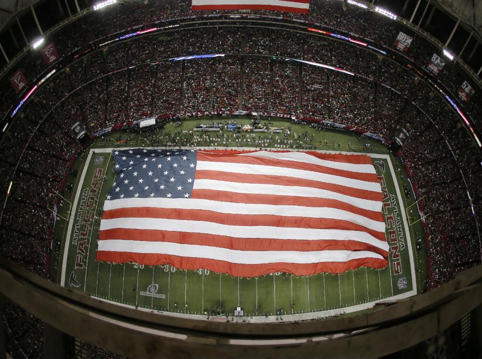 A flag is unveiled on the field at the Georgia Dome before the NFL football NFC championship game between the Green Bay Packers and the Atlanta Falcons Sunday, Jan. 22, 2017, in Atlanta. (AP Photo/John Bazemore)