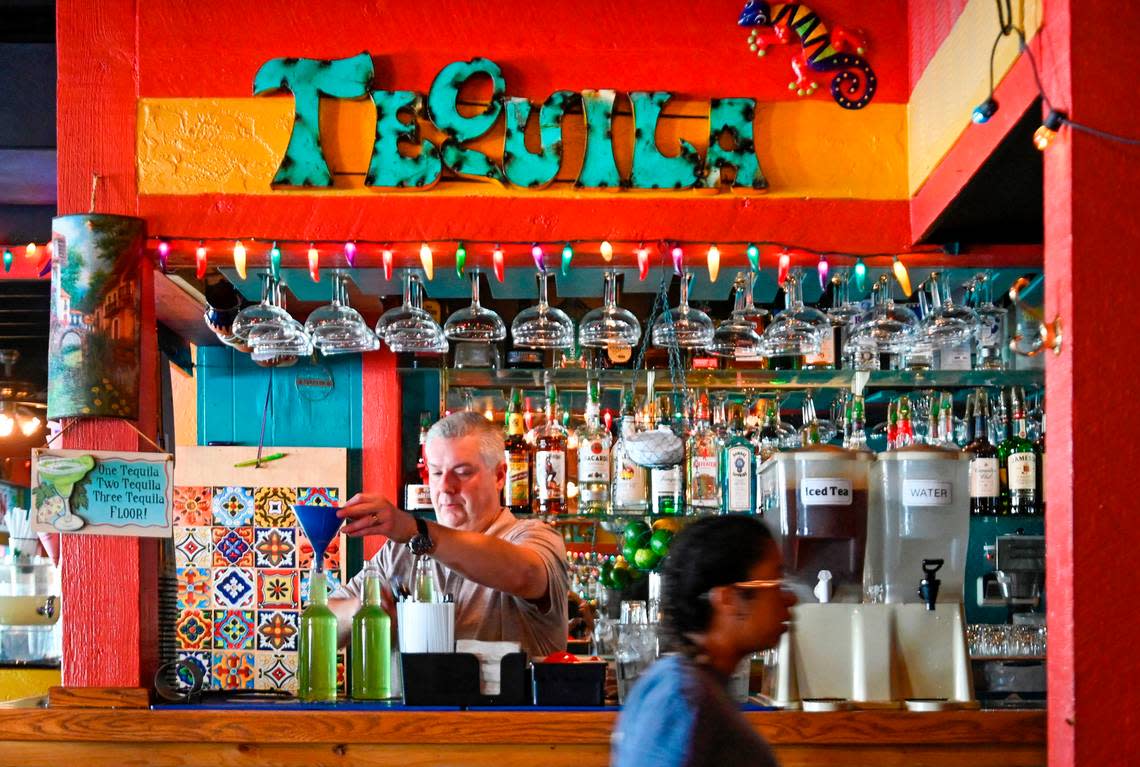 Brice Shockley, bartender and manager at Torreon Mexican Restaurant, fills bottles with house-made margaritas for carryout. His grandparents founded the restaurant in 1960.