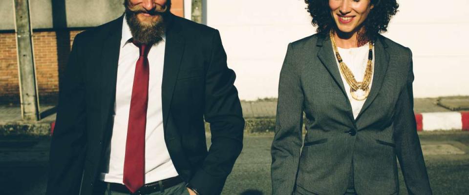 business man and business woman walking in parking lot outdoor