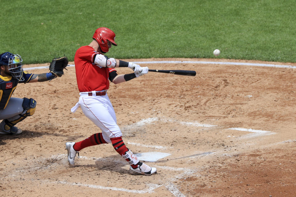 Cincinnati Reds' Jesse Winker hits a solo home run during the third inning of a baseball game against the Milwaukee Brewers in Cincinnati, Sunday, May 23, 2021. (AP Photo/Aaron Doster)