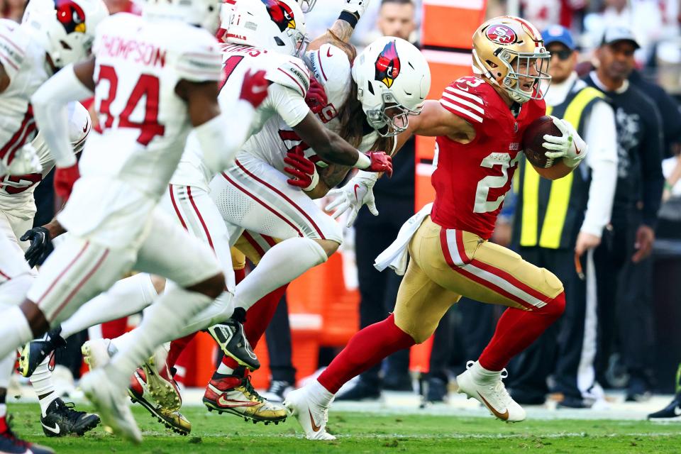 San Francisco 49ers running back Christian McCaffrey (23) runs with the ball during the first quarter against the Arizona Cardinals at State Farm Stadium in Glendale on Dec. 17, 2023.