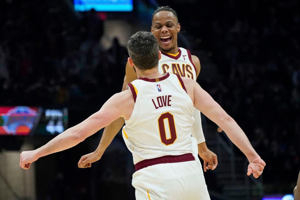 Cleveland guard Isaac Okoro and forward Kevin Love celebrate in the second half of a Monday night's win over the New York Knicks. [Tony Dejak/Associated Press]