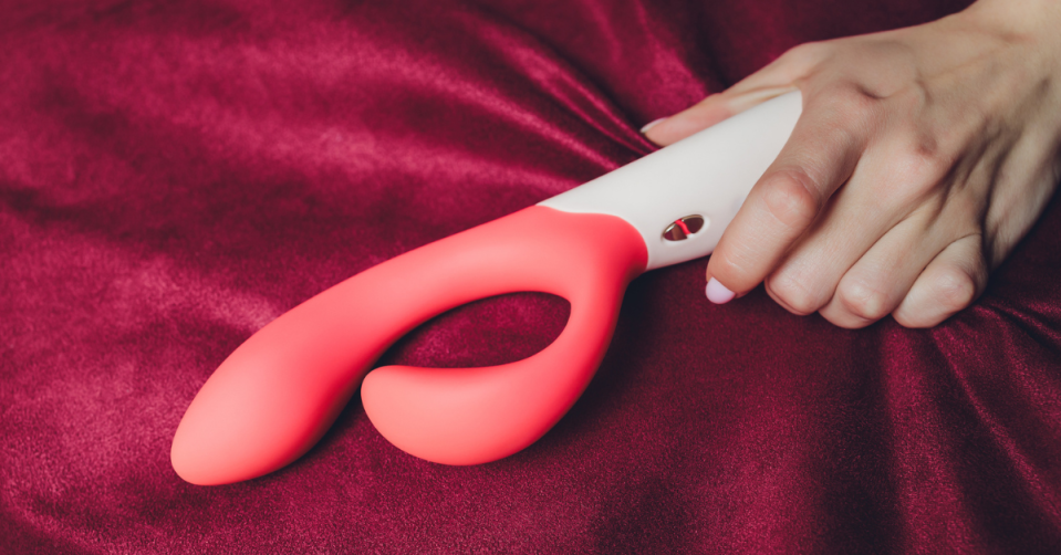 Woman's hand holding vibrator. 