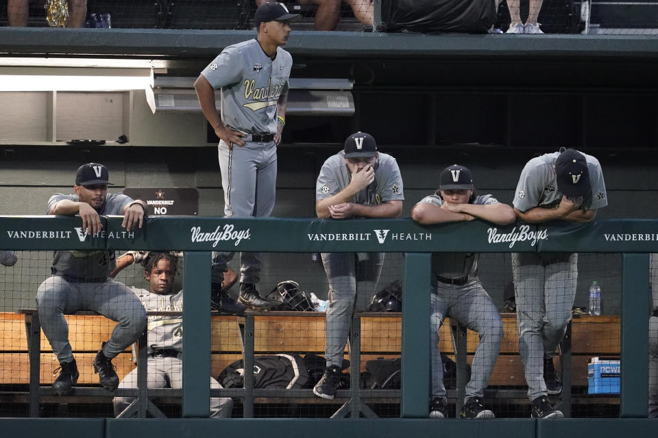 Vanderbilt players look out of the dugout as they lose to Xavier in an NCAA college baseball tournament regional elimination game Sunday, June 4, 2023, in Nashville, Tenn. (AP Photo/George Walker IV)