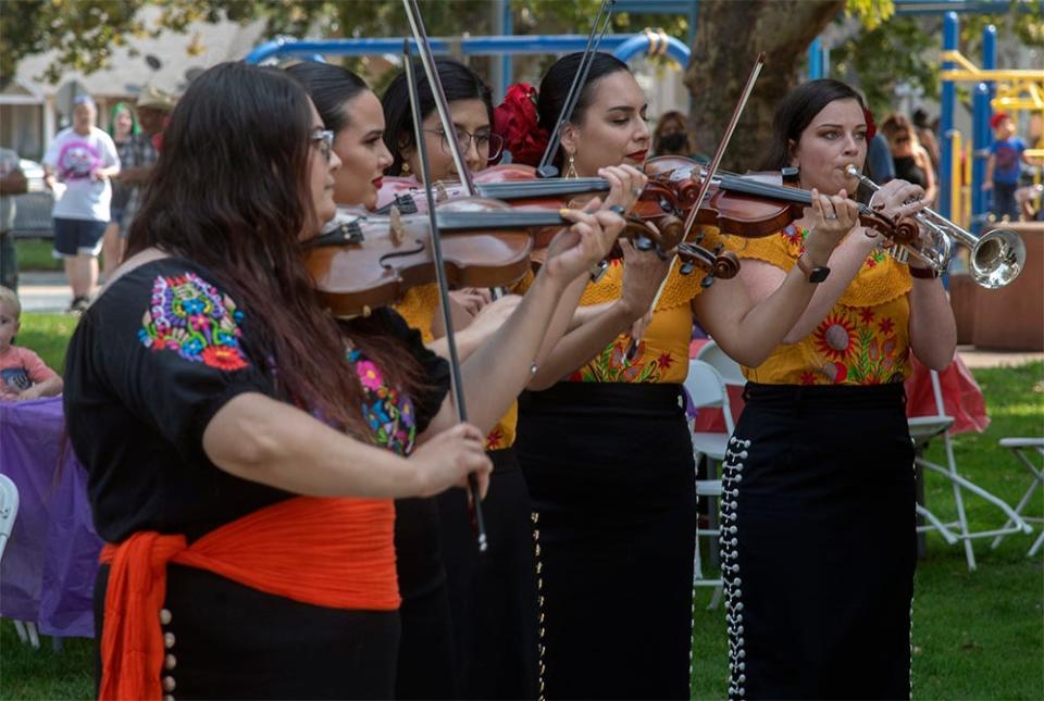 Members of the Mariachi Bonitas band perform at the Lodi Arts Commission's 10th annual Taco Truck Cook Off at Hale Park in Lodi. 