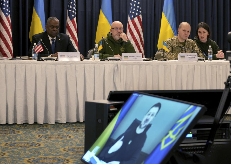US Defense Secretary Lloyd Austin, rear left, attends the opening speech of the President of Ukraine, Volodymyr Zelenskyy, (on video screen) during the meeting of the 'Ukraine Defense Contact Group' at Ramstein Air Base in Ramstein, Germany, Friday, Jan. 20, 2023. Defense leaders are gathering at Ramstein Air Base in Germany Friday to hammer out future military aid to Ukraine, amid ongoing dissent over who will provide the battle tanks that Ukrainian leaders say they desperately need(AP Photo/Michael Probst)