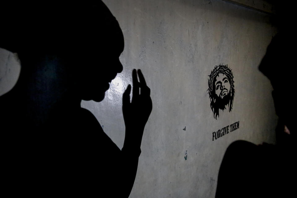 A teenage girl who became a sex worker after schools in Kenya were closed in March due to coronavirus restrictions, casts a shadow on the wall of the rented room where she and others work in Nairobi, Kenya Thursday, Oct. 1, 2020. The girls saw their mothers' sources of income vanish when Kenya's government restricted movement to prevent the spread of the virus, and now engage in the sex work to help with household bills. (AP Photo/Brian Inganga)