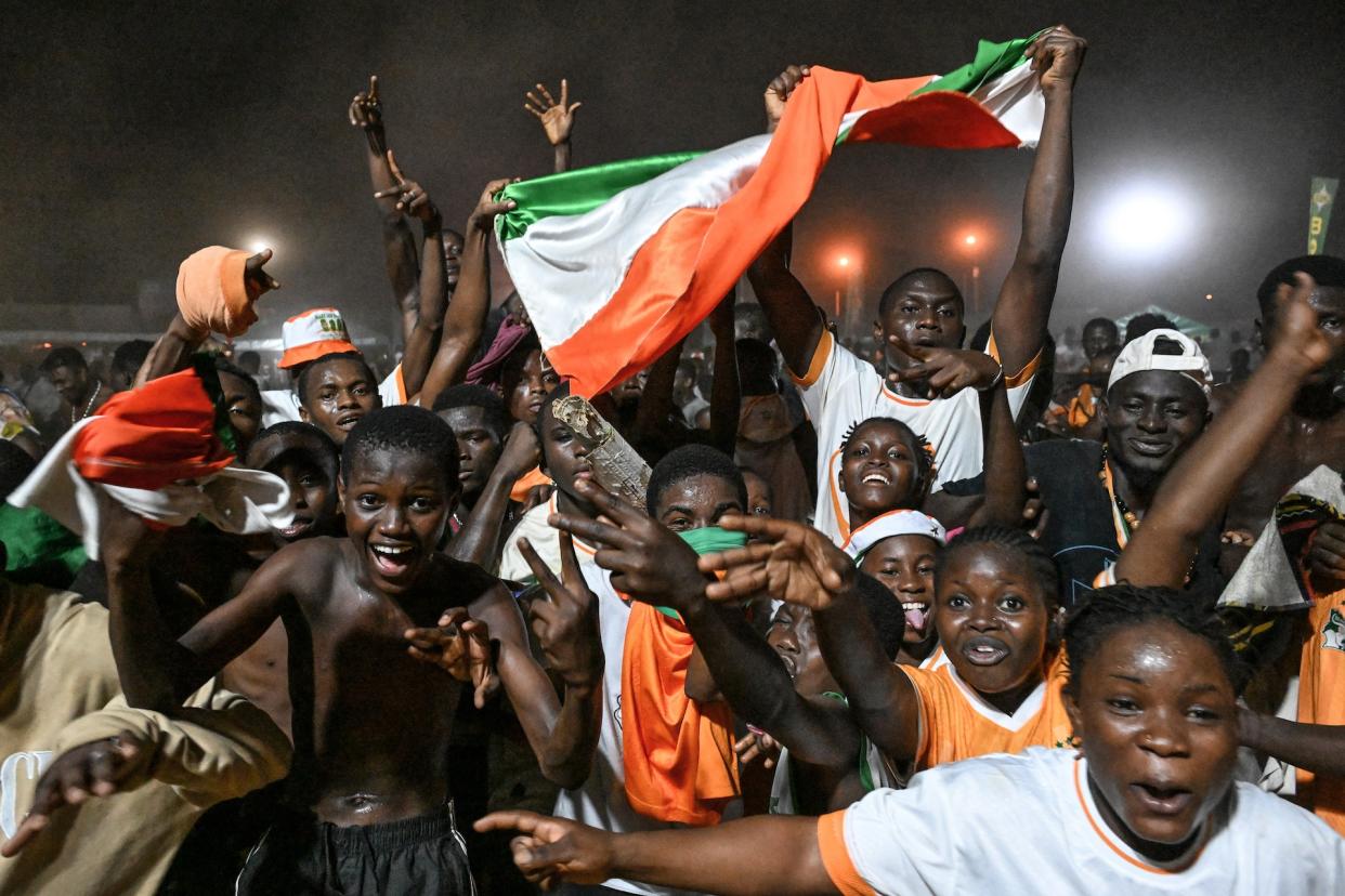 Fans of host nation Ivory Coast celebrate their team's quarterfinal victory. (Sia Kambou/AFP via Getty Images)