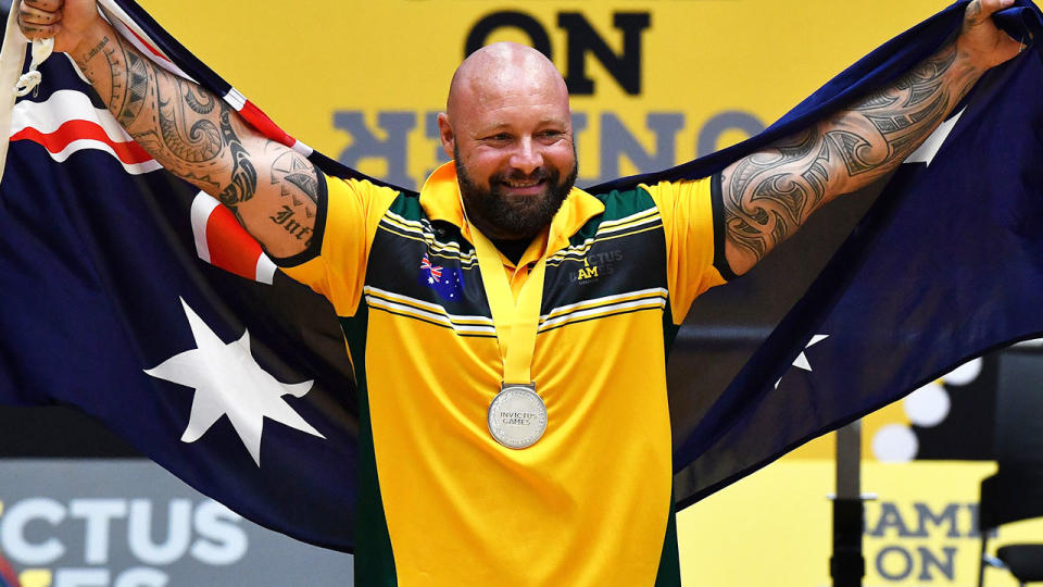 Australia’s Tyronne Gawthorne celebrates his silver medal in the men’s power weightlifting. (Photo by Saeed KHAN / AFP)