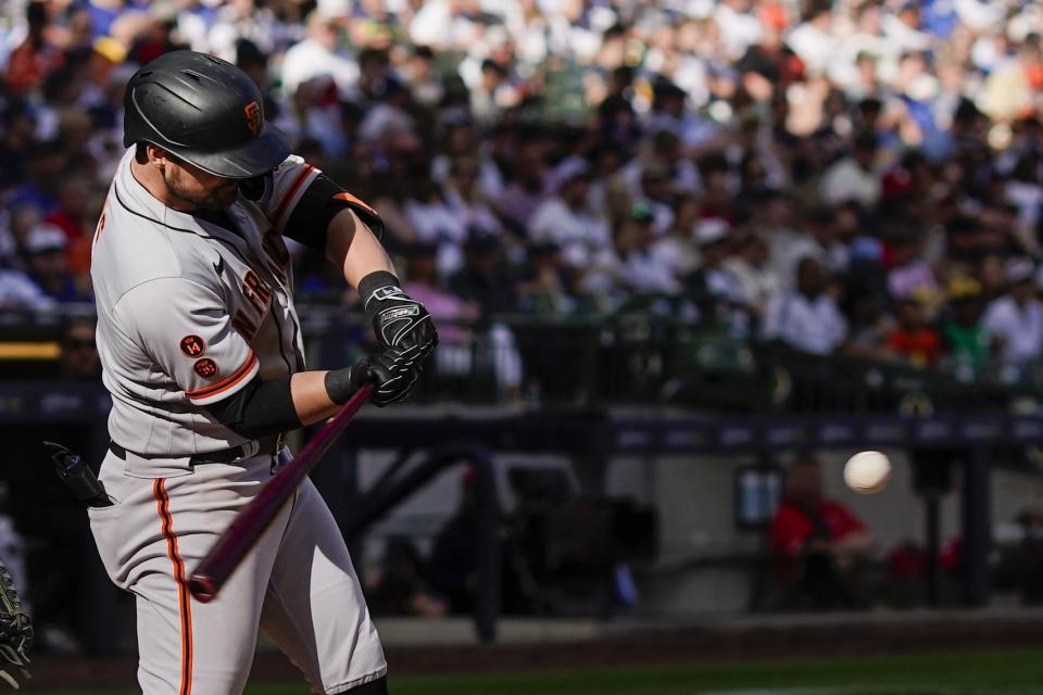 San Francisco Giants' J.D. Davis hits a single during the eighth inning of a baseball game against the Milwaukee Brewers Saturday, May 27, 2023, in Milwaukee. (AP Photo/Morry Gash)