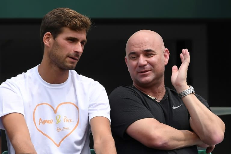 US coach Andre Agassi (R) and Marko Djokovic, the brother of Serbia's Novak Djokovic, attend his tennis match on May 29, 2017 in Paris