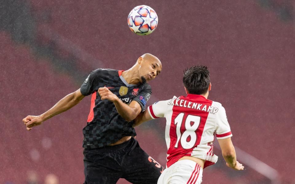 Fabinho of FC Liverpool and Razvan Marin of Ajax Amsterdam battle for the ball during the UEFA Champions League Group D stage match between Ajax Amsterdam and Liverpool FC at Johan Cruijff Arena on October 21, 2020 in Amsterdam, Netherlands - Getty Images Europe /DeFodi Images 