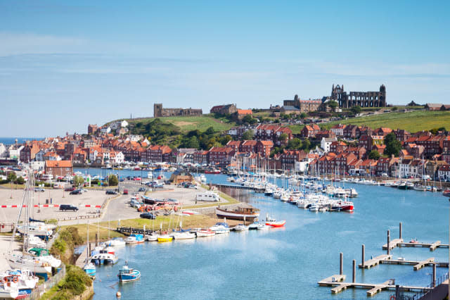 The North Yorkshire seaside town of Whiby, with its Abbey on the headland, the River Esk, and houses clustered around the harbou