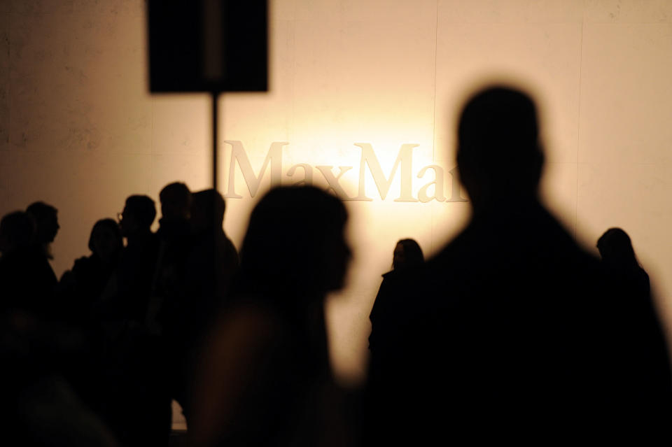 Guests wait for the start of the Max Mara women's Fall-Winter 2014-15 collection, part of the Milan Fashion Week, unveiled in Milan, Italy, Thursday, Feb. 20, 2014. (AP Photo/Giuseppe Aresu)