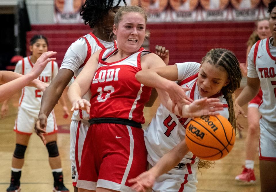 Lodi's Janie Schallberger, left, fights for a rebound with Lincoln's Jaeda Bates during a girls varsity basketball game at Lincoln High in Stockton on Jan. 25, 2024.