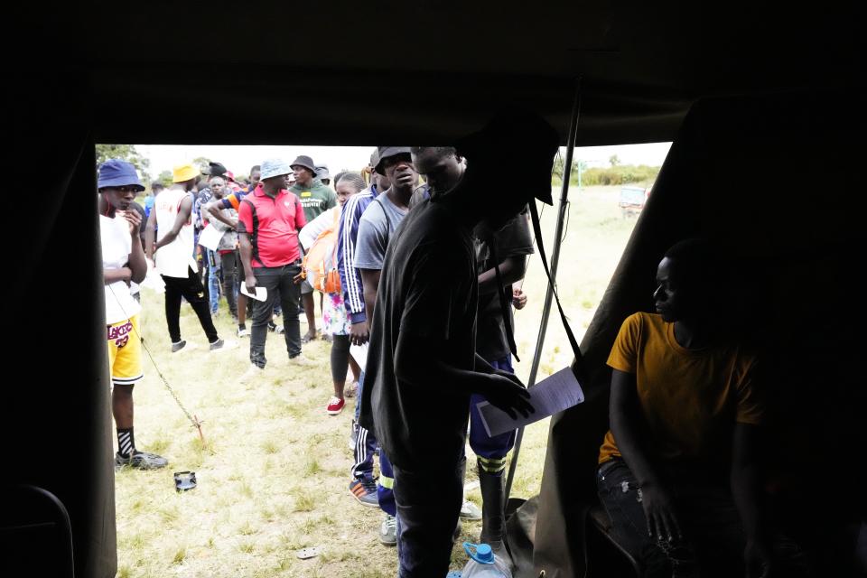 People wait in a queue to register to vote in Harare, on March, 17, 2023. Zimbabwe's President Emmerson Mnangagwa's recently announced that national elections will be held on Aug 23. Allegations of fraud, violence and harassment of opposition members have characterized elections held in Zimbabwe since independence from white minority rule in 1980. (AP Photo/Tsvangirayi Mukwazhi)