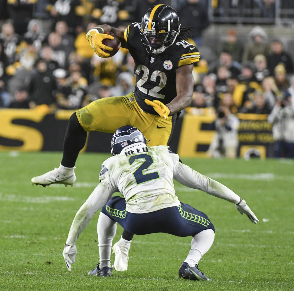 Pittsburgh Steelers running back Najee Harris (22) tries to leap over Seattle Seahawks cornerback D.J. Reed as he runs the ball during the second half an NFL football game, Sunday, Oct. 17, 2021, in Pittsburgh. (AP Photo/Fred Vuich)