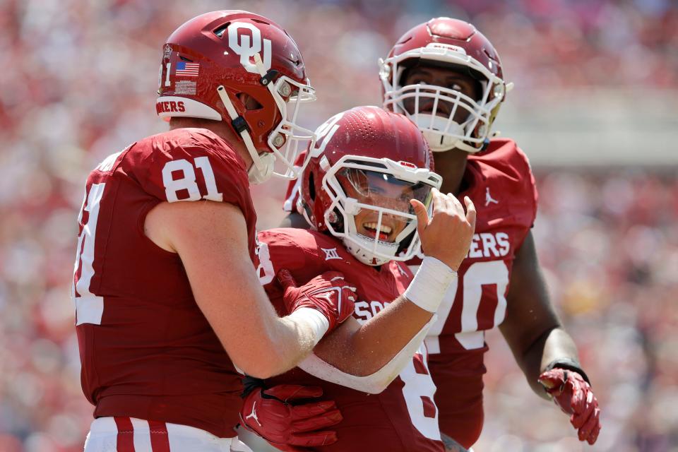 Oklahoma’s <a class="link " href="https://sports.yahoo.com/ncaaf/players/299857" data-i13n="sec:content-canvas;subsec:anchor_text;elm:context_link" data-ylk="slk:Dillon Gabriel;sec:content-canvas;subsec:anchor_text;elm:context_link;itc:0">Dillon Gabriel</a> (8) celebrates beside <a class="link " href="https://sports.yahoo.com/ncaaf/players/299357" data-i13n="sec:content-canvas;subsec:anchor_text;elm:context_link" data-ylk="slk:Austin Stogner;sec:content-canvas;subsec:anchor_text;elm:context_link;itc:0">Austin Stogner</a> (81) and Cayden Green (70) after running for a touchdown during a college football game between the University of Oklahoma Sooners (OU) and the <a class="link " href="https://sports.yahoo.com/ncaaf/teams/arkansas-st/" data-i13n="sec:content-canvas;subsec:anchor_text;elm:context_link" data-ylk="slk:Arkansas State Red Wolves;sec:content-canvas;subsec:anchor_text;elm:context_link;itc:0">Arkansas State Red Wolves</a> at Gaylord Family-Oklahoma Memorial Stadium in Norman, Okla., Saturday, Sept. 2, 2023.