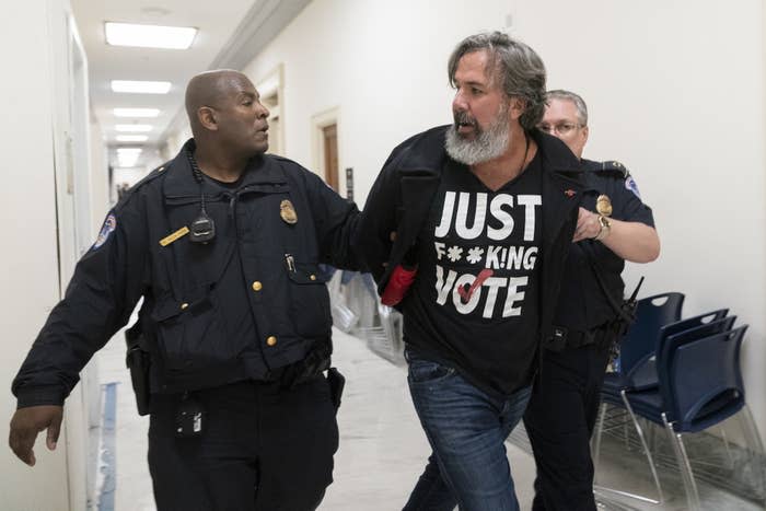 Manuel Oliver, the father of Joaquin Oliver, one of the victims of the 2018 mass shooting at Marjory Stoneman Douglas High School in Parkland, Florida, is removed from the hearing room on Capitol Hill on March 23, 2023.