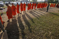 Cambodian Buddhist monks wait in queue for entering into the courtroom before the hearings against two former Khmer Rouge senior leaders, at the U.N.-backed war crimes tribunal on the outskirts of Phnom Penh, Cambodia, Friday, Nov. 16, 2018. The U.N.-backed tribunal judging the criminal responsibility of former Khmer Rouge leaders for the deaths of an estimated 1.7 million Cambodians will issue verdicts Friday in the latest — and perhaps last — of such trials. (AP Photo/Heng Sinith)