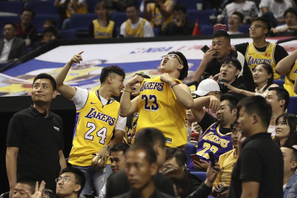 Chinese fans react during a preseason NBA basketball game between the Brooklyn Nets and Los Angeles Lakers at the Mercedes Benz Arena in Shanghai, China, Thursday, Oct. 10, 2019. (AP Photo)