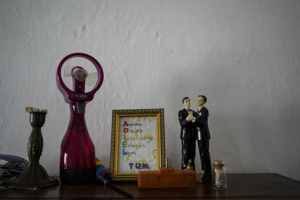 Figurines representing grooms stand on display in the home of partners Lázaro “Lachi” González and Adiel González in Matanzas, Cuba, Thursday, Oct. 7, 2021. The socialist government recently published a draft Family Law and asked for public comment ahead of a referendum on legalizing same-sex marriage, as well as expanding grandparents rights, allowing for prenuptial agreements and in cases of divorce, create financial consequences for those who have committed gender violence, amid a total of 480 articles. (AP Photo/Ramon Espinosa)