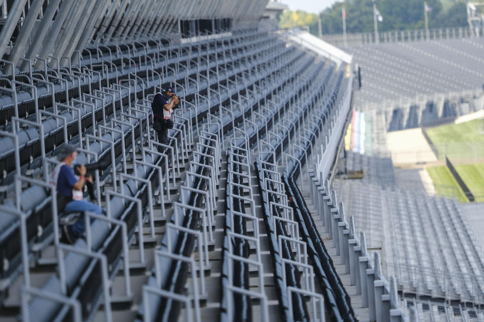 Credentialed media are the only people in the stands during the Indianapolis 500 IndyCar auto race at the Indianapolis Motor Speedway, Sunday, Aug. 23, 2020, in Indianapolis. (AP Photo/AJ Mast)