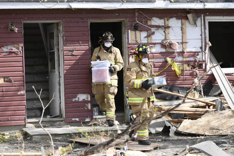 <p>Ottawa firefighters carry out personal items from a home damaged by a tornado in Dunrobin, Ont., west of Ottawa, on Sunday, Sept. 23, 2018. The storm tore roofs off of homes, overturned cars and felled power lines in the Ottawa community of Dunrobin and in Gatineau, Que. (Photo from Justin Tang/The Canadian Press) </p>