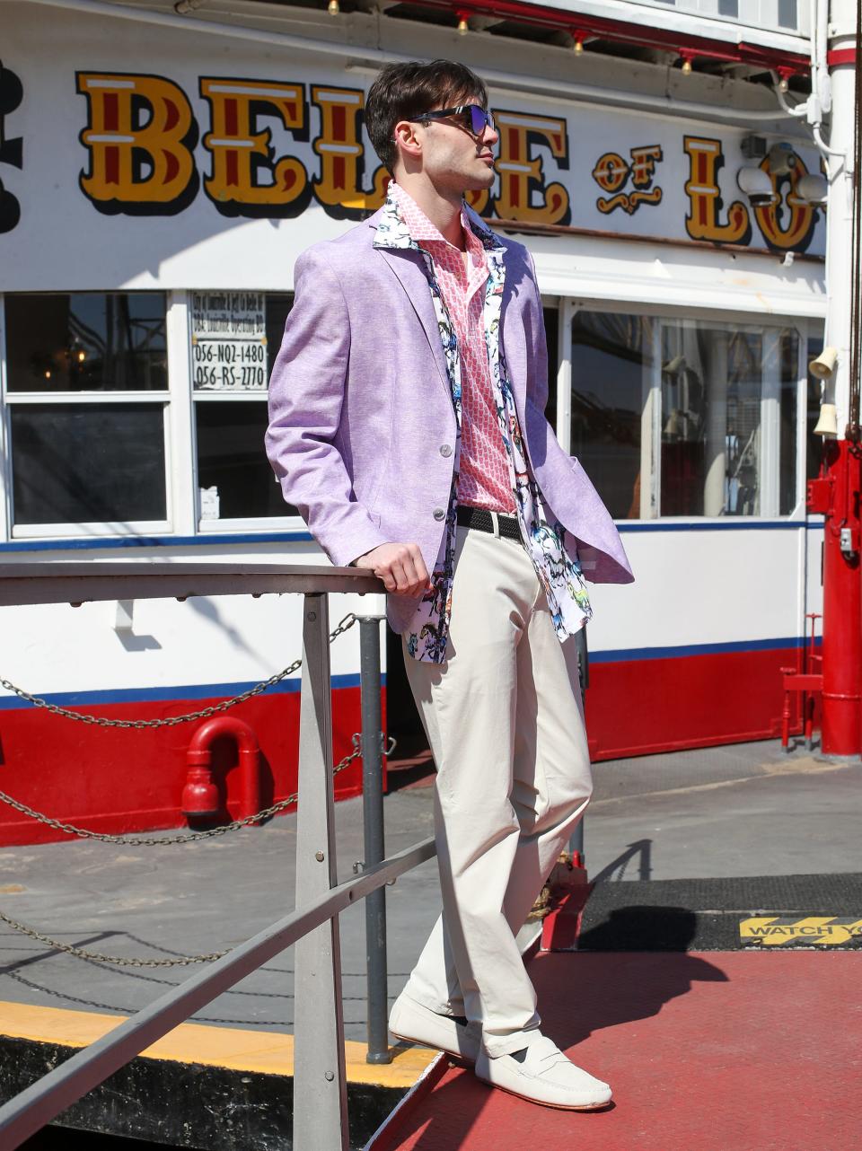 On the Belle of Louisville, Caden Stover models a shirt with a mint julep cup print by Vineyard Vines ($110), a Robert Graham button-down with horse motif ($238), and a linen Robert Graham jacket ($498). These Kentucky Derby men's outfit ideas are available at Von Maur