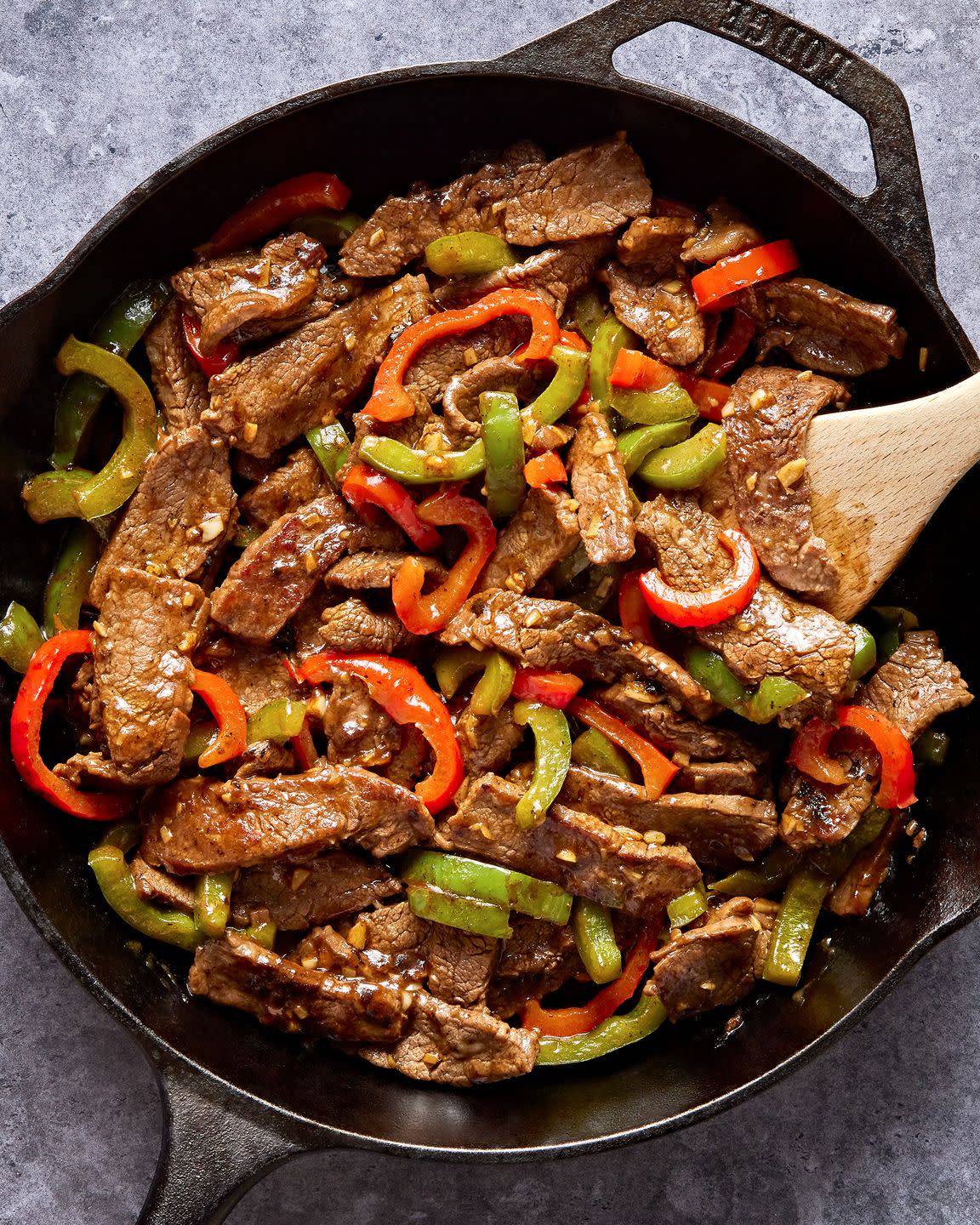 steak with sliced red and green peppers