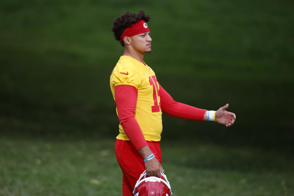 Kansas City Chiefs quarterback Patrick Mahomes walks to the field before a morning workout at the team's NFL football training camp facility at Missouri Western State University in St. Joseph, Mo., Sunday, July 24, 2022. (AP Photo/Colin E. Braley)