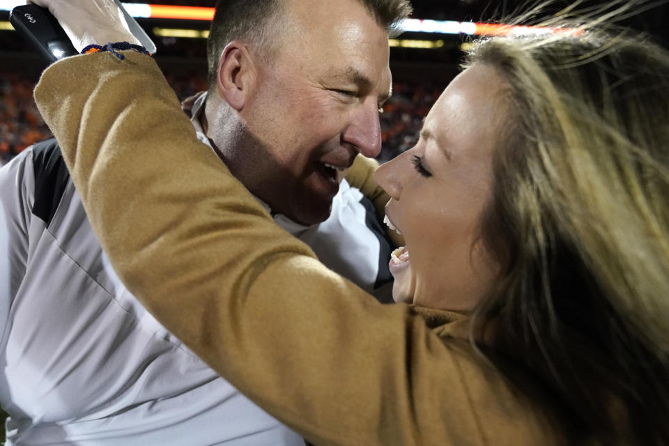 Illinois head coach Bret Bielema is hugged by his wife Jennifer Hielsberg after the team's 9-6 win over Iowa in an NCAA college football game Saturday, Oct. 8, 2022, in Champaign, Ill. (AP Photo/Charles Rex Arbogast)