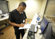 Radiology manager Marshall C. Pritchett Jr. works on a file at Thomasville Regional Medical Center in Thomasville, Ala., on Tuesday, May 3, 2022. The hospital is among three in the nation that say they are missing out on federal pandemic relief money because they opened during or shortly before the COVID-19 crisis began. (AP Photo/Jay Reeves)