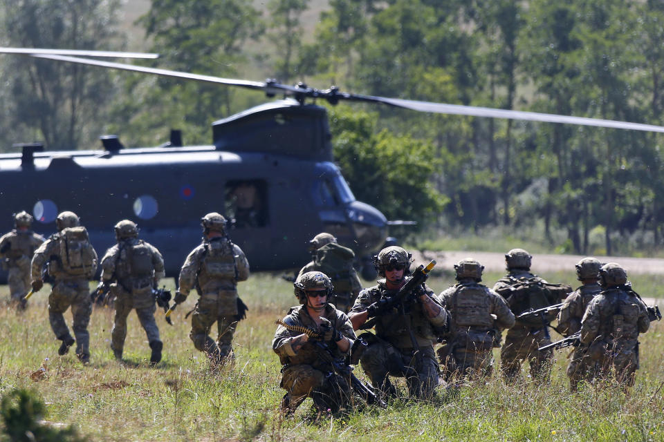 FILE - In this Aug. 26, 2015, file photo, soldiers take part in an exercise of the U.S. Army Global Response Force in Hohenfels, Germany. There will be leaders and populations who shudder at the thought of four more years of the Donald Trump administration and those whose consternation is tied to his potential defeat, and a U.S. government led by a President Joe Biden. Trump has demanded U.S. troops are pulled out of ally Germany, where they have been based for decades, prompting the Pentagon into a plan that will cost billions of dollars and take years to complete. (AP Photo/Matthias Schrader, File)