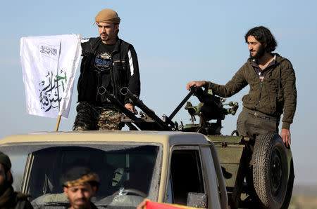 FILE PHOTO: Turkish-backed Syrian rebels stand on the back of a truck at Manbij countryside, Syria December 29, 2018. REUTERS/Khalil Ashawi/File Photo