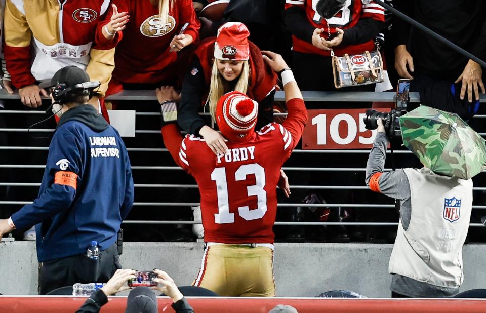 Brock Purdy hugs Jenna Brandt, following a game between the San Francisco 49ers and the Seattle Seahawks on January 14, 2023 in Santa Clara, California.