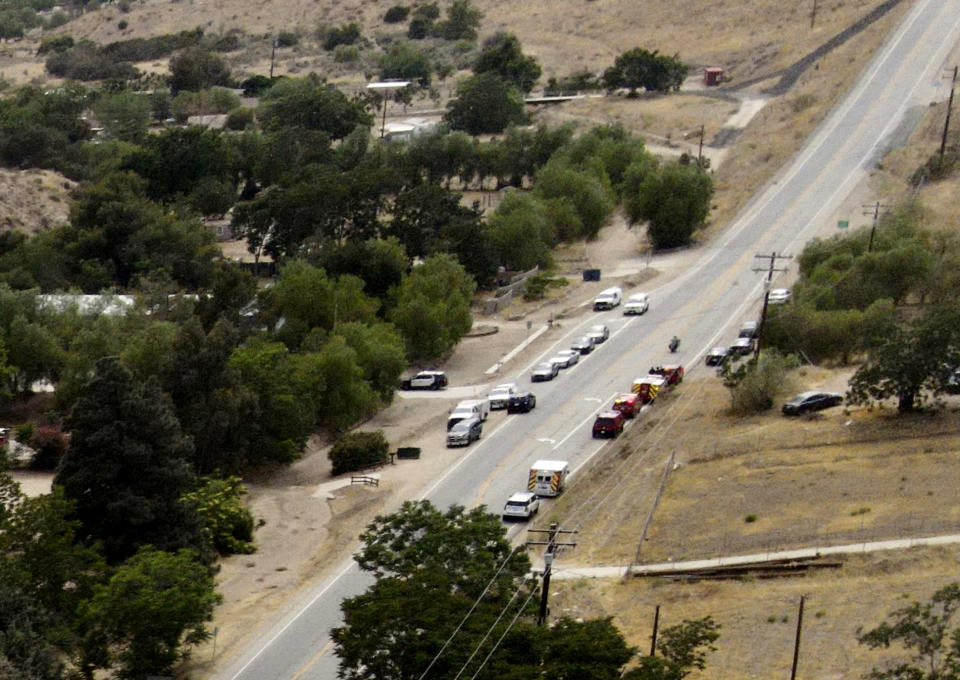 Law enforcement personnel close off a road during an investigation of a shooting at Fire Station 81 in Santa Clarita, Calif., Tuesday, June 1, 2021. (AP Photo/David Swanson)