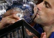 Serbia's Novak Djokovic kisses the men's singles trophy after winning his final match against Britain's Andy Murray at the Australian Open tennis tournament at Melbourne Park, Australia, January 31, 2016. REUTERS/Jason O'Brien Action Images via Reuters